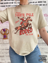 Load image into Gallery viewer, North Pole Rodeo Tee or Crewneck
